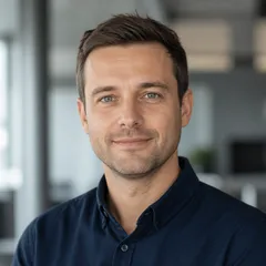 Professional author portrait of a fictional person with a neutral, trustworthy expression in a smart casual outfit against a 